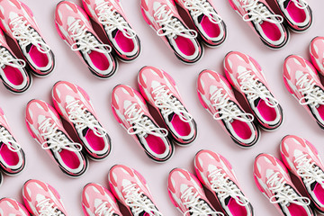 Fashion women's sneakers on a pink background. Female sport shoes.  Fitness concept. Top view, flat lay