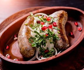 Grilled sausage in a clay pot. Georgian restaurant.