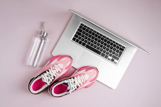 Laptop, Sneakers And Water Bottle On A Pink Background. Online Fitness Program. Home  Workout. Top View, Flat Lay