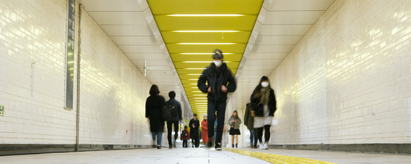 Pedestrians wearing surgical masks in subway station, Tokyo, Japan　マスクをつけた人々...