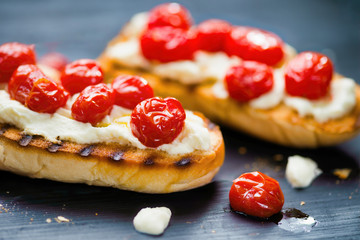 rustic italian bruschetta with caramelized cherry tomatoes and ricotta cheese