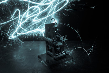 Death penalty electric chair miniature on dark. Creative artwork decoration.