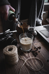 hand holding a cup of latte