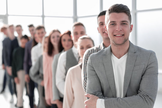 Confident Guy Standing In Line Of Diverse Young People