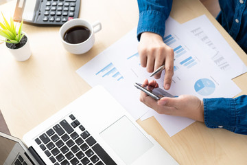 Businessman checking the business reports from the financial imformation from smartphone. Online...