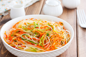 Funchoza salad with fresh cucumbers and Korean carrots, selective focus