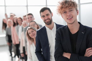 Fototapeta premium confident guy standing in front of a group of young people