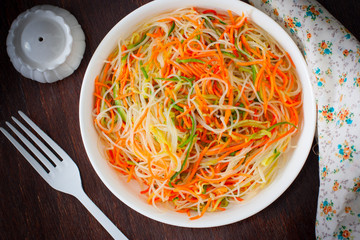Funchose salad with fresh cucumbers and Korean carrots, selective focus, top view