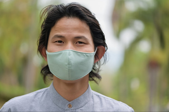 Man Wearing A Cloth Mask In Public Area Protect Himself From Risk Of Disease, People Prevent Infection From Coronavirus Covid-19 Or Air Pollution