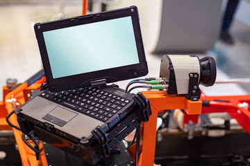 Laptop with a blank monitor. The laptop is connected to the machine. Laptop wires are connected to...