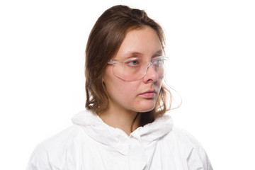 Fototapeta premium Portrait of young nurse in protective white medical uniform during coronavirus pandemic. Epidemic, pandemic of coronavirus covid 19.