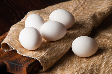 Chicken eggs on burlap, rustic still life