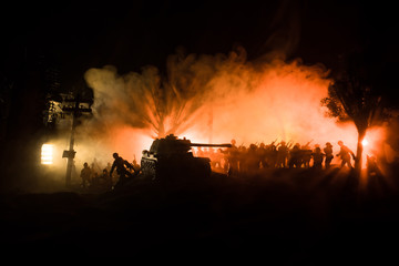 Fototapeta na wymiar War Concept. Armored vehicle silhouette fighting scene on war foggy sky background at night.