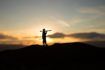 War Concept. Military silhouettes fighting scene on war fog sky background,