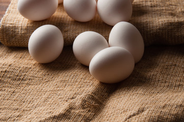 Chicken eggs on burlap, rustic still life