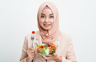 Healthy halal food, green salad and asian muslim healthy girl concept - Happy Asian muslim eating...