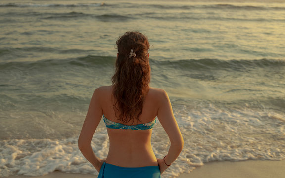 Young woman practicing pranayama and meditation at the beach. Hands in gyan mudra. Anti stress. Melasti beach, Bali, Indonesia