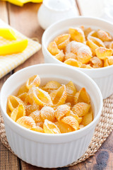 Pasta casserole with egg in white ceramic tins, selective focus