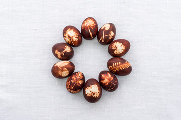 Dyed eastereggs on a white background layed in a circle