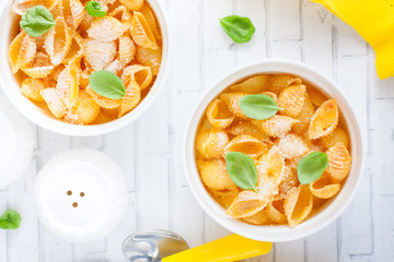 Pasta casserole with egg in white ceramic tins, selective focus