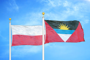 Poland and Antigua and Barbuda  two flags on flagpoles and blue cloudy sky