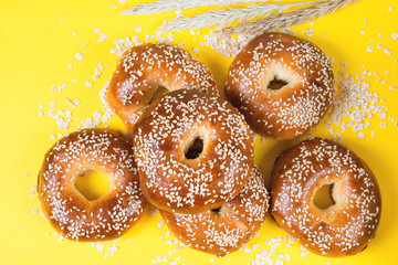 Creative layout of bagels on a bright yellow background