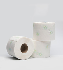
Three rolls of toilet paper on a white background