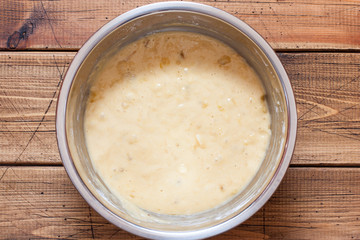 Step by step preparation of banana bread, step 4 - kneading the dough, top view, selective focus