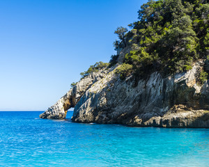 Naklejka premium The famous stone arch of Cala Goloritze on the Gulf of Orosei in Sardinia, Italy