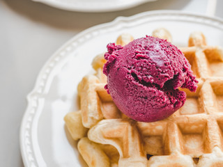 Homemade ice cream and fragrant waffles, lying on the table. Close-up, view from above. Tasty and healthy eating concept