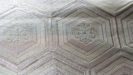 Background with macro closeup on a silver Japanese traditional clothing kimono waistband with hexagon shaped pattern