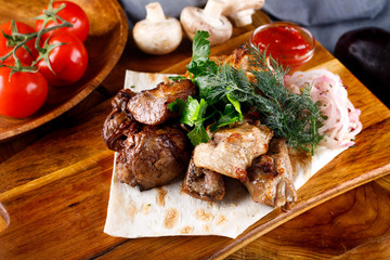 juicy fried chicken legs and meat with herbs accompanied by sauce and ingredients