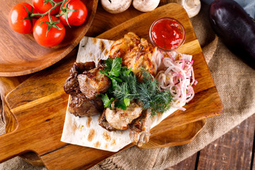 juicy fried chicken legs and meat with herbs accompanied by sauce and ingredients