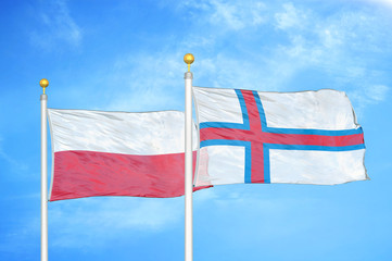 Poland and Faroe Islands two flags on flagpoles and blue cloudy sky