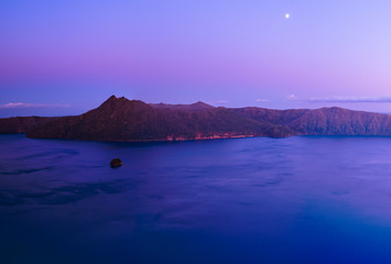 beautiful morning caldera lake with moon