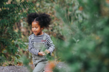 Children hiking in mountains or forest. Kids Camping summer. American African funny little girls...