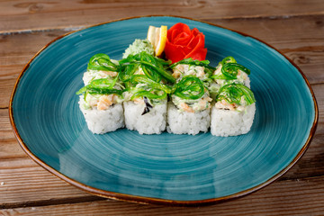 Rolls, wasabi, soy sauce, ginger on the table, avocado.