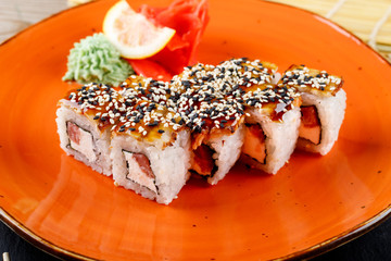 Rolls, wasabi, soy sauce, ginger on the table, avocado.