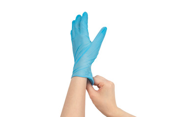 Woman puts on blue rubber gloves.