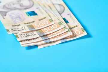 Ukrainian money on blue background. Payment of pensions, salaries. Bank loan. Business concept