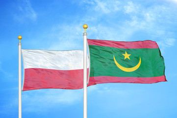 Poland and Mauritania two flags on flagpoles and blue cloudy sky