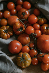 Heirloom tomatoes from the garden. Tomatoes of different classes on antique wooden surface. Assorted tomatoes 