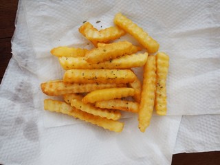 french fries on a plate put on tissue paper absorb oil lean