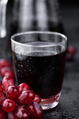 Portion of healthy Red Grape Juice (selective focus; close-up shot)