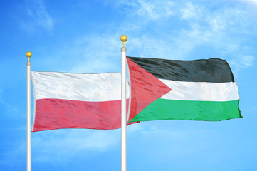 Poland and Palestine two flags on flagpoles and blue cloudy sky