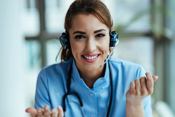 Happy female doctor working at medical call center.