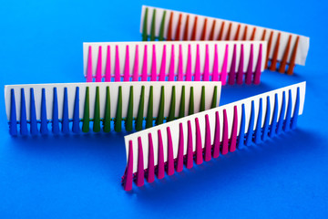 on a blue background hair clips of different colors in sets on a cardboard frame