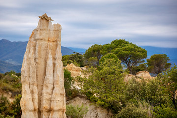 Natural chimneys made up of columns of soft rock, eroded by rain in Les Orgues d'illes sur Tet. Languedoc Roussillon, France - 335825102