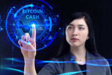 Business, Technology, Internet and network concept. Young businessman working on a virtual screen of the future and sees the inscription: Bitcoin cash