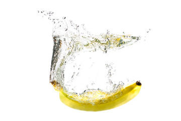 one banana falling into water on a white background with splashes